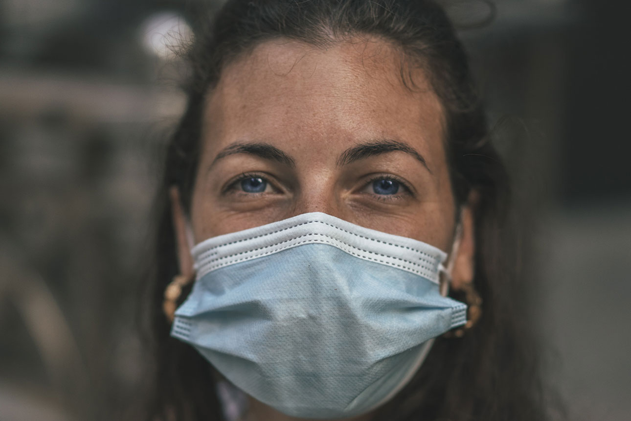 a female wearing a blue medical facemask