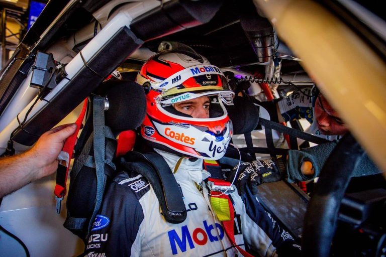 Nick Percat wearing racing helmet in a supercar cockpit
