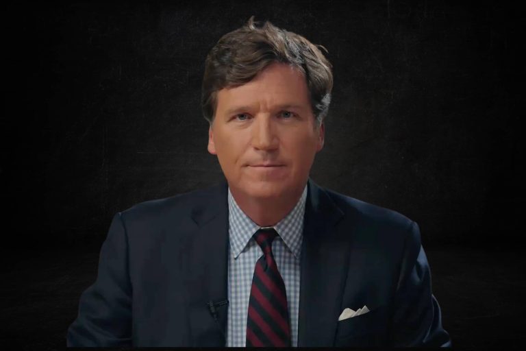 Tucker Carlson looking serious with a black background
