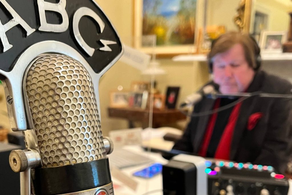 Jeremy Cordeaux at the dining room table with a vintage microphone