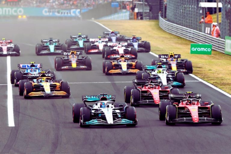 Formula one cars racing off the line