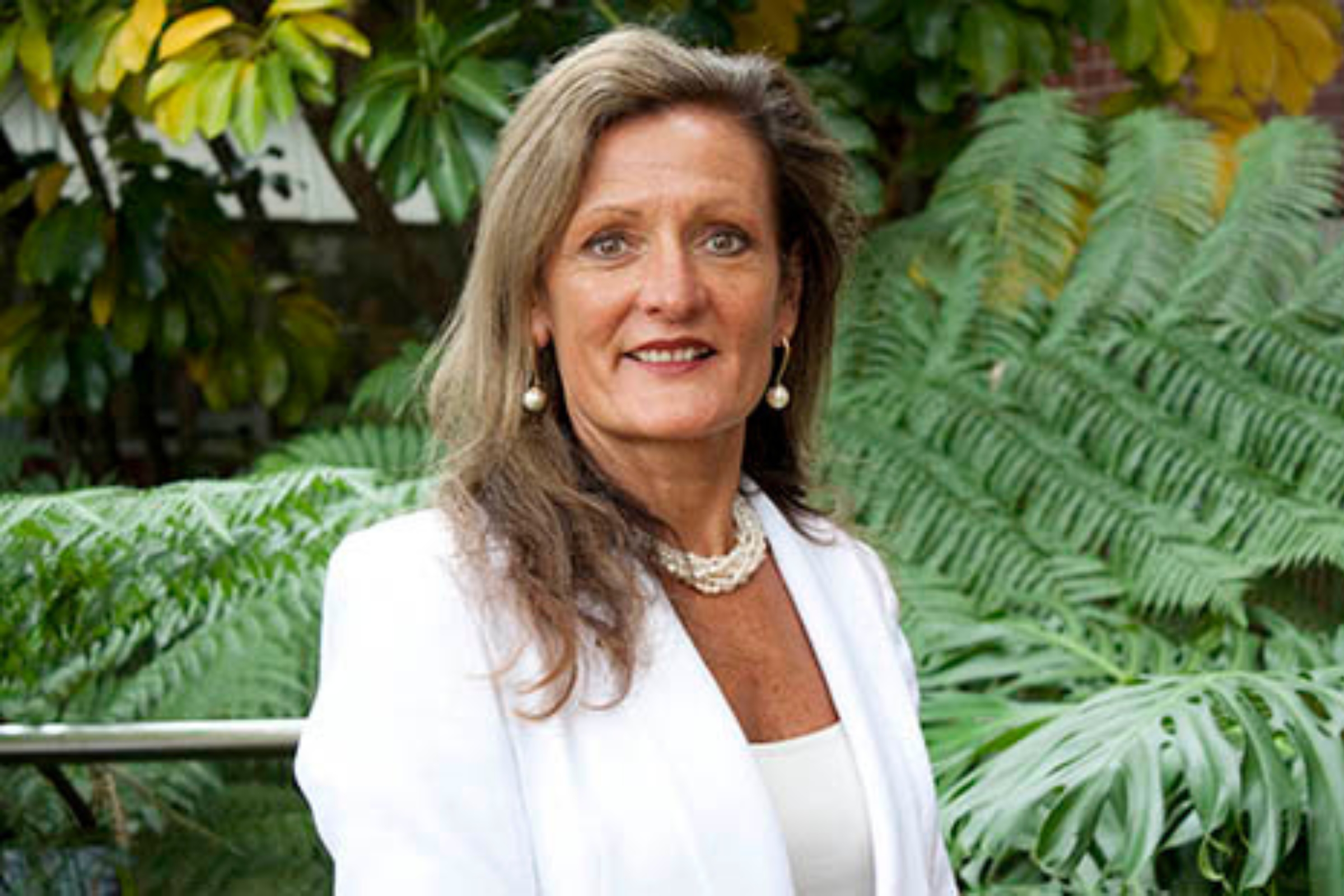 Professor Tonia Gray standing in front of some ferns