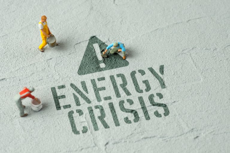 Text saying "Energy Crisis" with little model people walking around the text