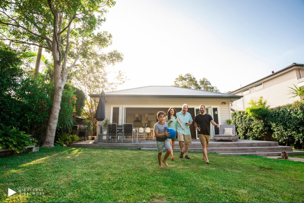 A family out the back of their home. About the housing crisis