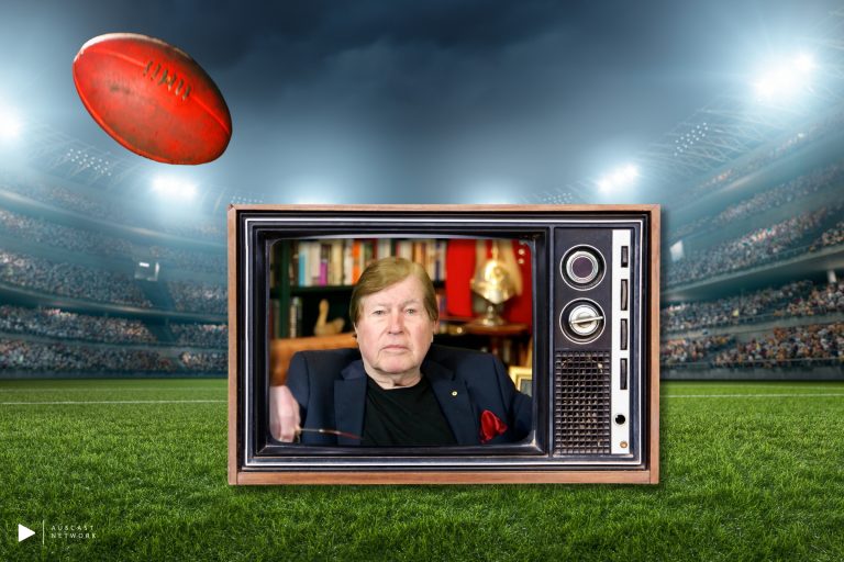 Jeremy Cordeaux on a TV postioned on an AFL oval at nighttime with a Football flying overhead