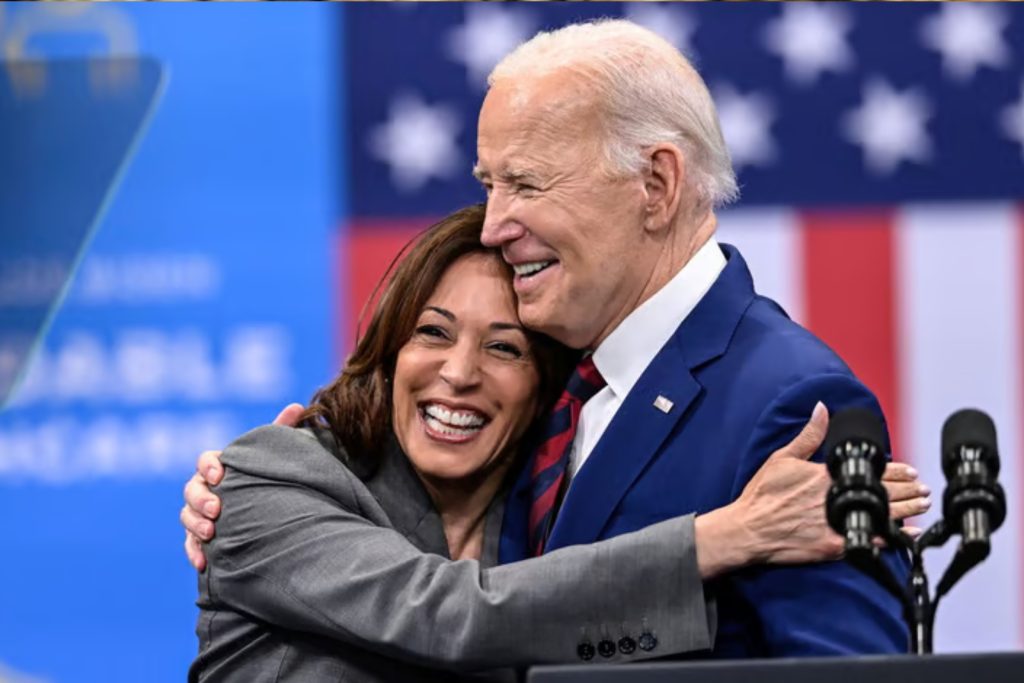 Kamala Harris and President Joe Biden hugging and smiling on stage