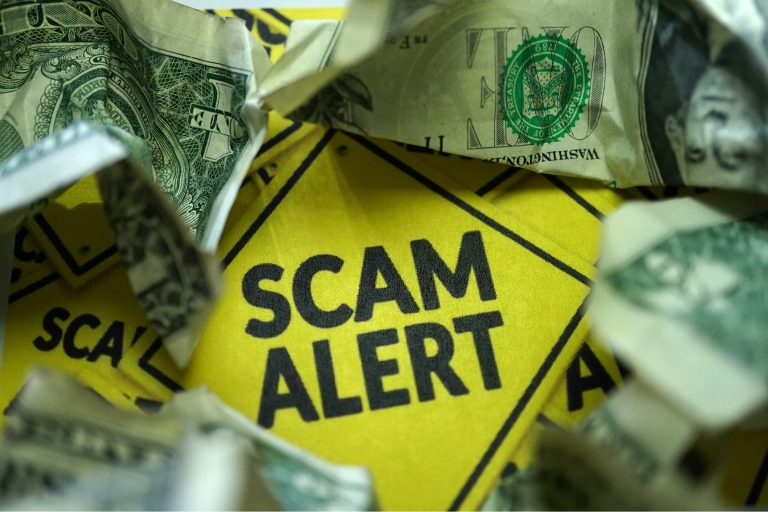 A Yellow warning sign that says SCAM Alert