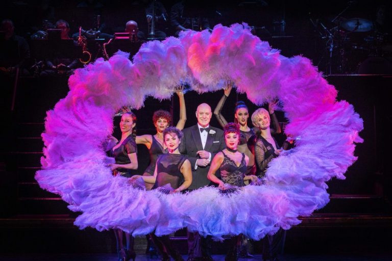 Australian cast of Chicago The Musical in a purple material feather